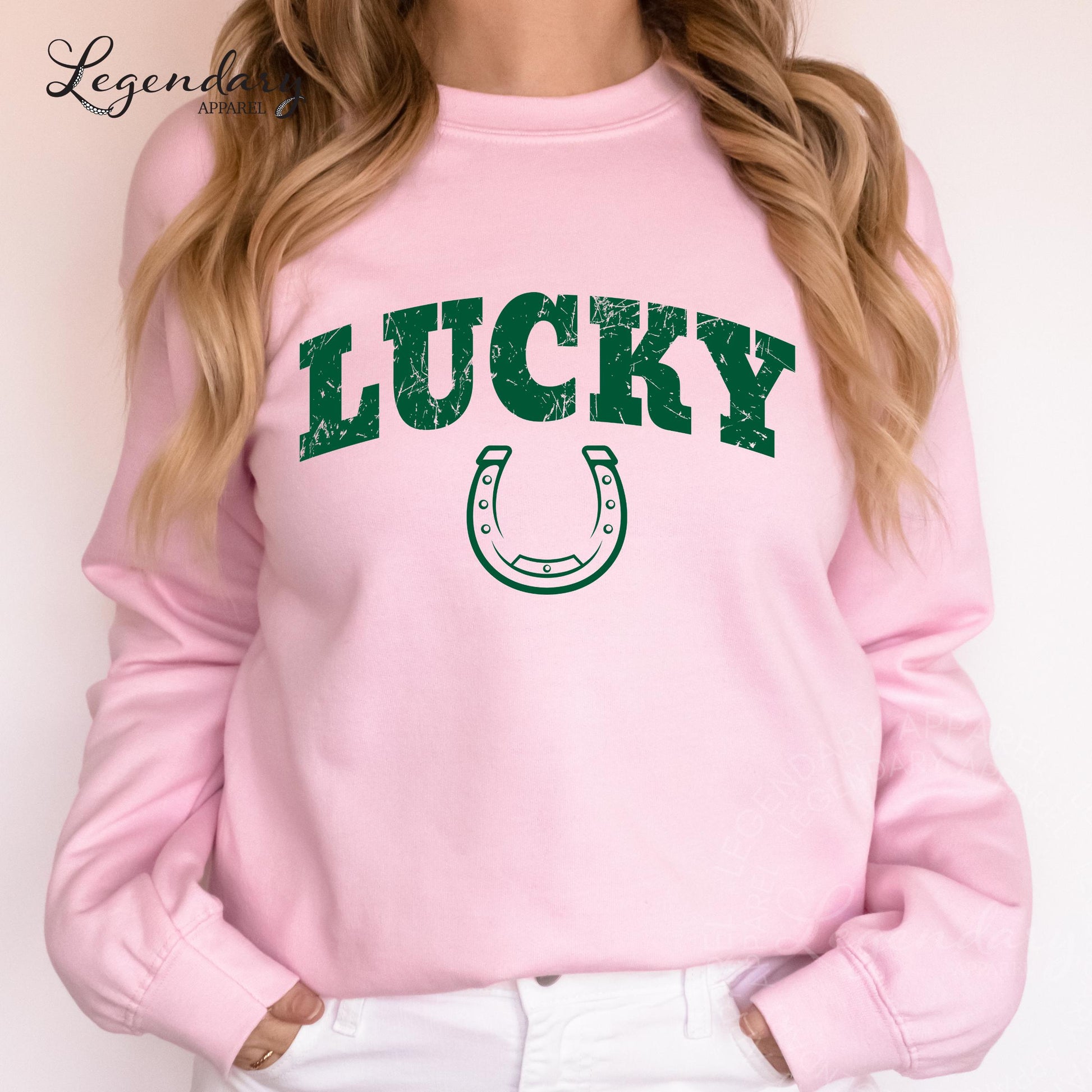 A woman wearing a pink sweatshirt with the word "Lucky" printed on it.