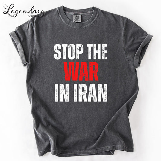 A gray t-shirt with the text "STOP THE WAR IN IRAN" printed on it in white and red lettering.